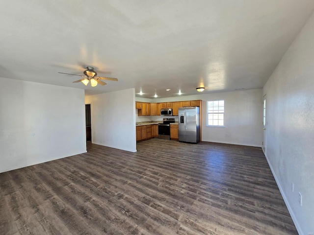 unfurnished living room featuring dark hardwood / wood-style floors and ceiling fan