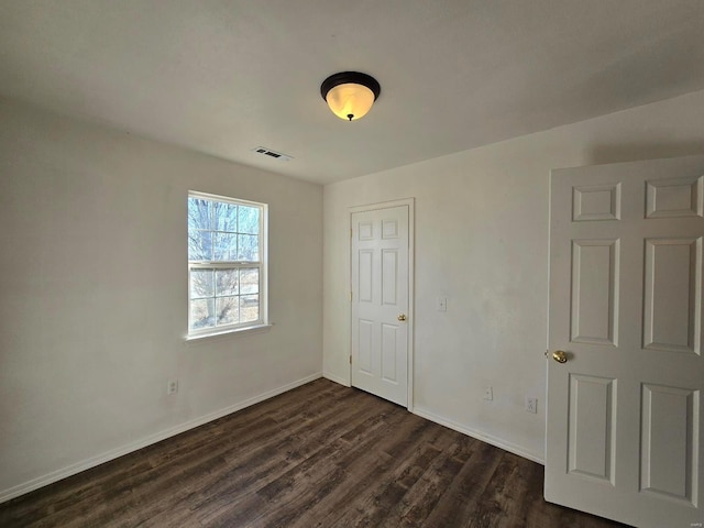 unfurnished bedroom with dark hardwood / wood-style floors