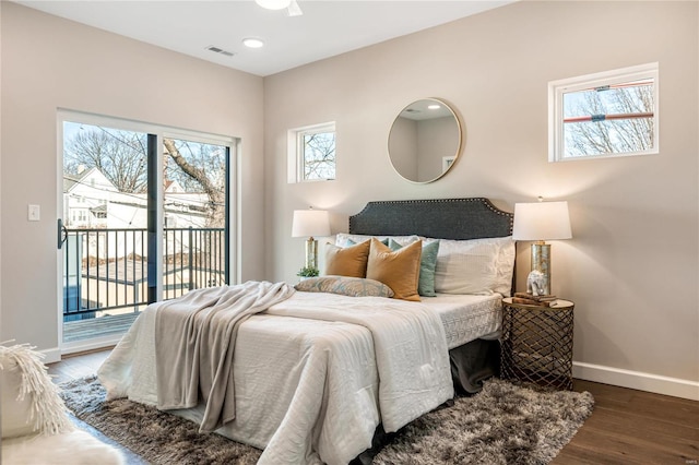 bedroom with dark hardwood / wood-style floors and access to exterior