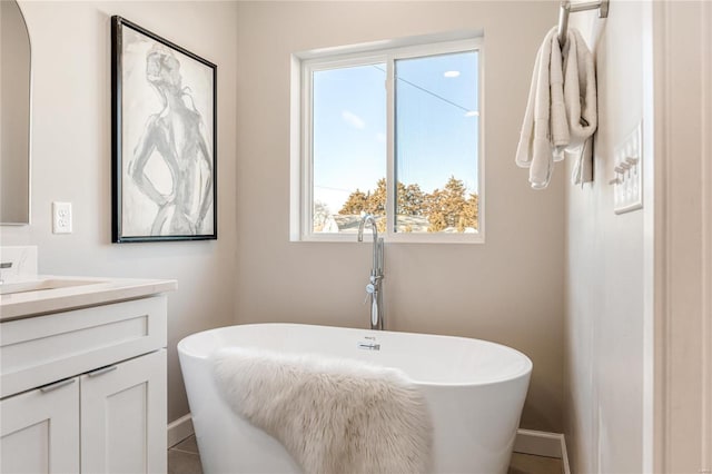 bathroom featuring vanity and a tub