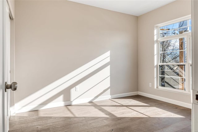 empty room with light hardwood / wood-style flooring