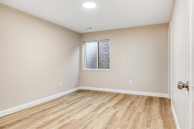 unfurnished room with light hardwood / wood-style floors