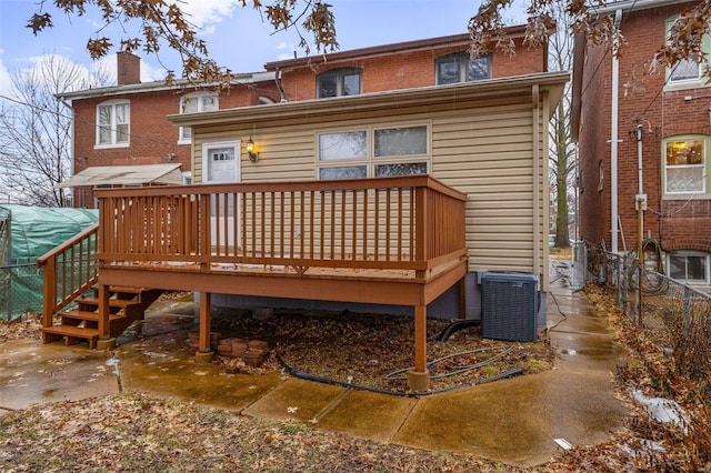 rear view of property with central AC and a deck