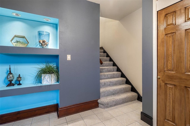 stairs featuring tile patterned flooring