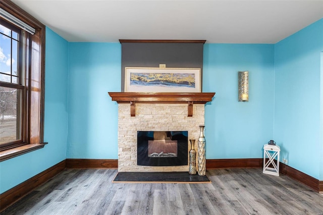 unfurnished living room featuring wood-type flooring and a fireplace