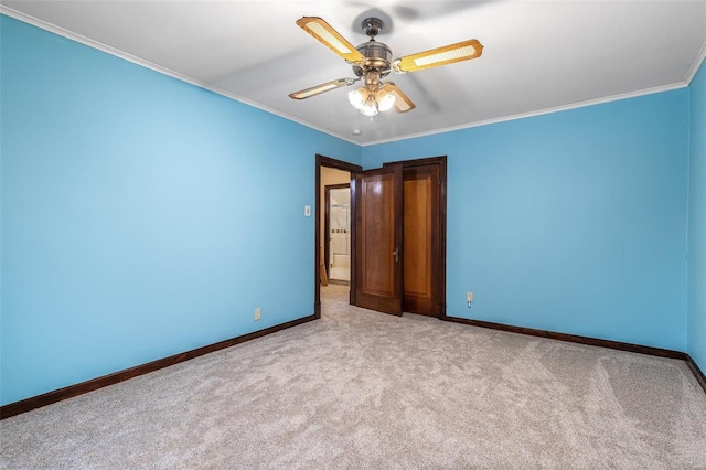 unfurnished bedroom with crown molding, light colored carpet, and ceiling fan