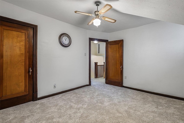 unfurnished room featuring light carpet and ceiling fan