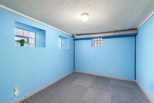 basement with carpet floors and a textured ceiling