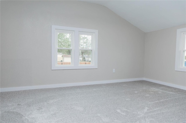 additional living space with carpet flooring and vaulted ceiling