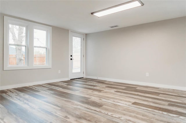 unfurnished room with light hardwood / wood-style flooring