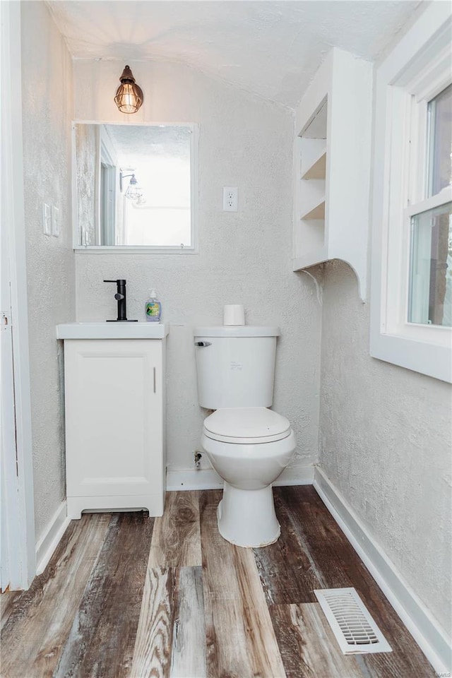 bathroom featuring hardwood / wood-style flooring, vanity, and toilet