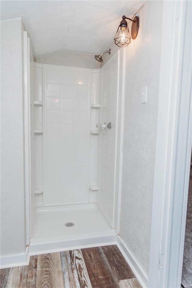 bathroom featuring hardwood / wood-style floors and a shower