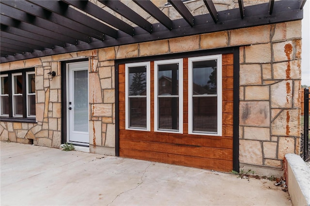 entrance to property featuring a patio