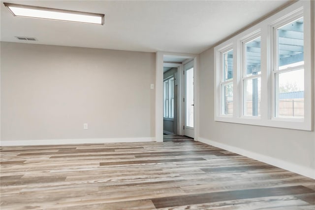 spare room with light hardwood / wood-style flooring