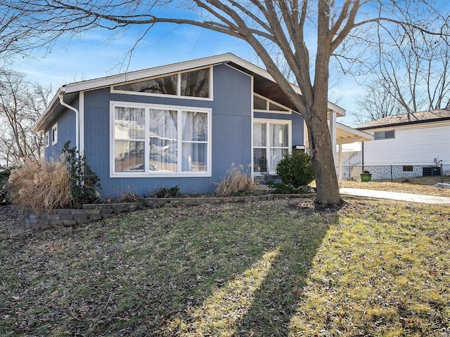 view of side of home with a lawn