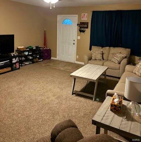 carpeted living room with ceiling fan