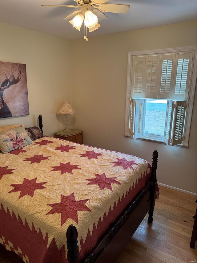 bedroom with hardwood / wood-style flooring and ceiling fan