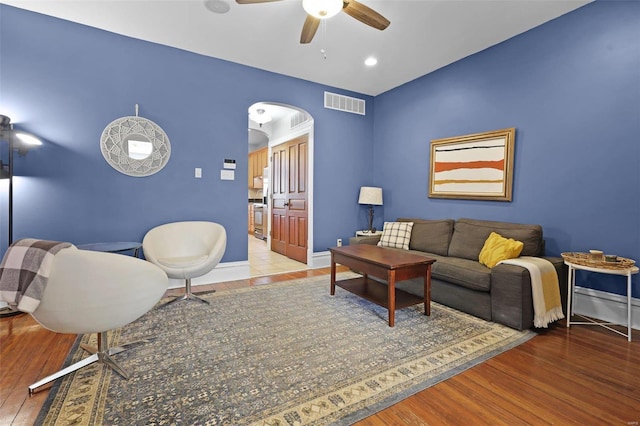 living room with hardwood / wood-style floors and ceiling fan