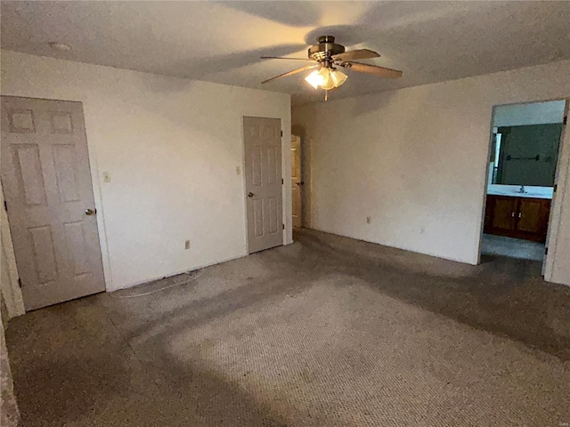 carpeted empty room featuring ceiling fan