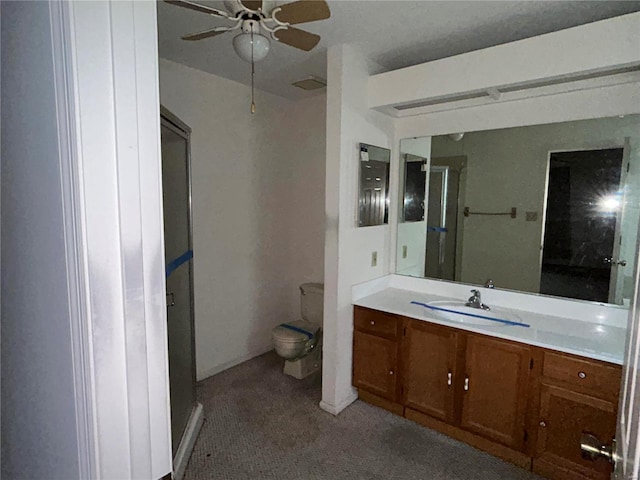 bathroom featuring vanity, ceiling fan, and toilet