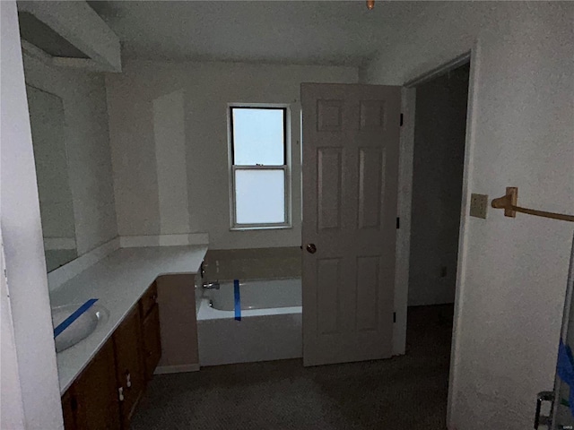 bathroom featuring a tub to relax in and vanity