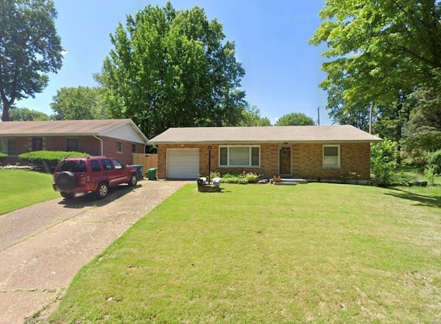 ranch-style house featuring a garage and a front lawn