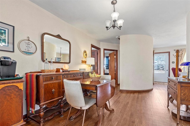 dining area featuring a chandelier and hardwood / wood-style floors