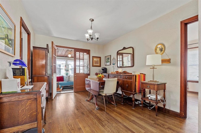 dining room featuring dark wood-type flooring and a notable chandelier