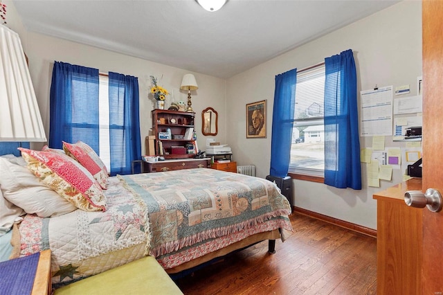 bedroom featuring hardwood / wood-style floors and radiator heating unit