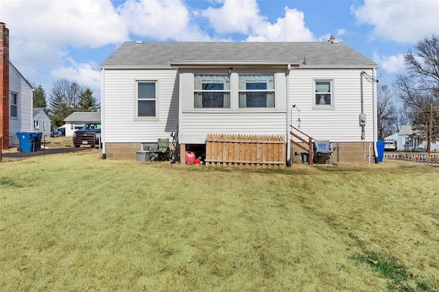 rear view of property with a yard