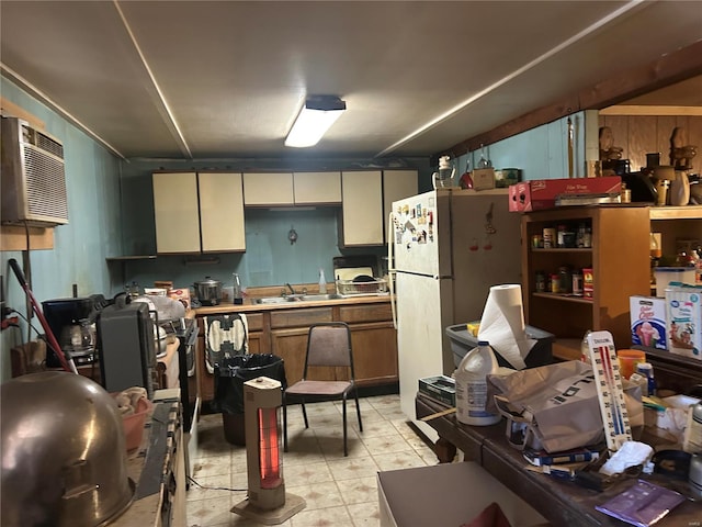 kitchen with white fridge, sink, a wall mounted AC, and wooden walls