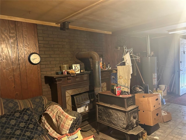 interior space featuring water heater, a wood stove, and wooden walls