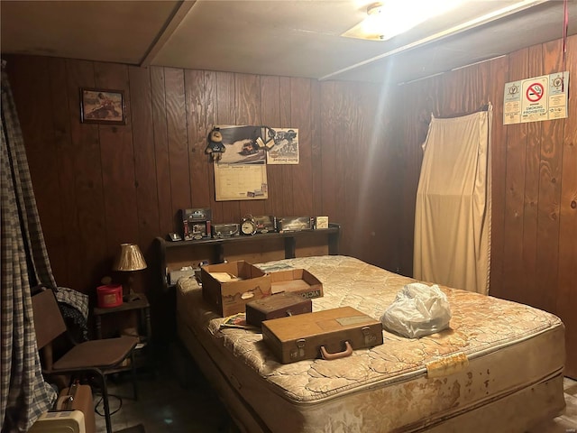 bedroom featuring wooden walls