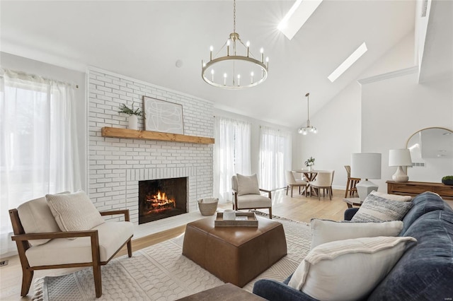 living room featuring a healthy amount of sunlight, an inviting chandelier, and light hardwood / wood-style floors