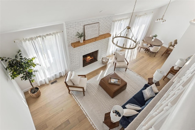 living room with a healthy amount of sunlight, a fireplace, and hardwood / wood-style floors