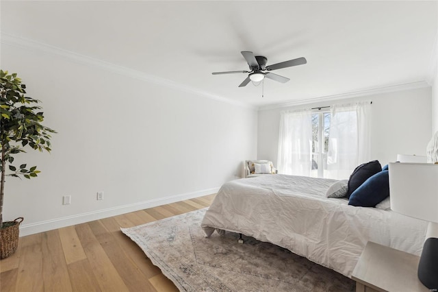 bedroom with light hardwood / wood-style flooring, ornamental molding, and ceiling fan