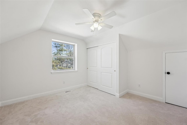 bonus room featuring ceiling fan, vaulted ceiling, and light carpet