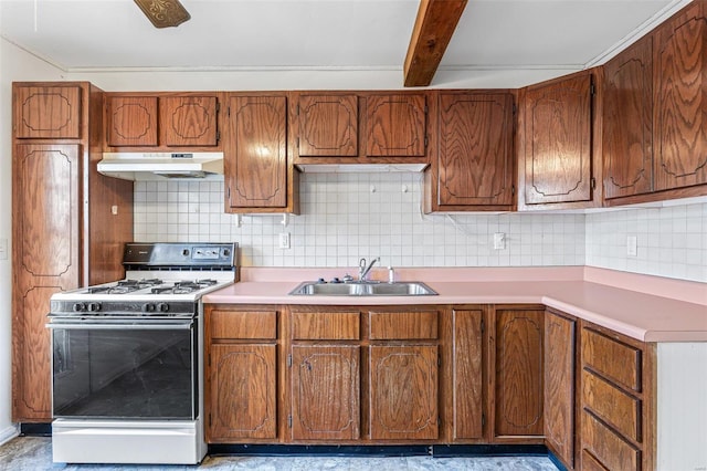 kitchen featuring beamed ceiling, sink, gas range gas stove, and backsplash