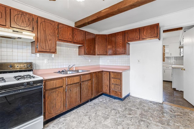 kitchen featuring beamed ceiling, tasteful backsplash, sink, and range with gas cooktop