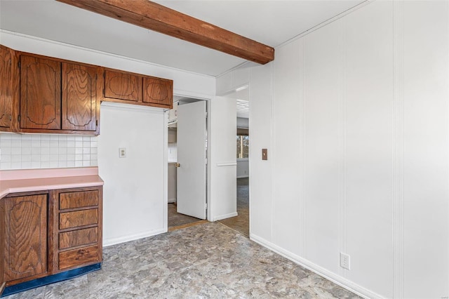 kitchen with decorative backsplash and beamed ceiling