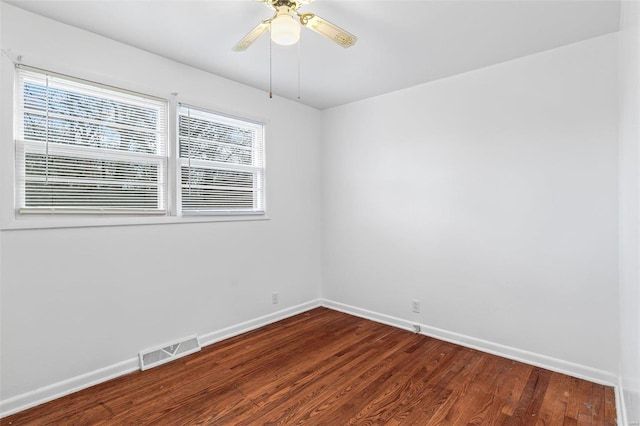 spare room with dark hardwood / wood-style floors and ceiling fan