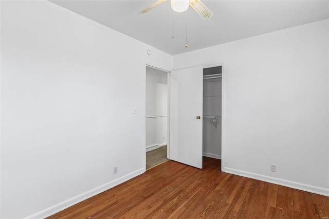 unfurnished bedroom featuring dark hardwood / wood-style flooring, a closet, and ceiling fan