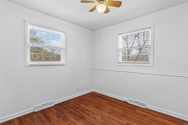 unfurnished room with dark hardwood / wood-style floors and ceiling fan