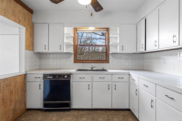 kitchen featuring white cabinetry, black dishwasher, and sink