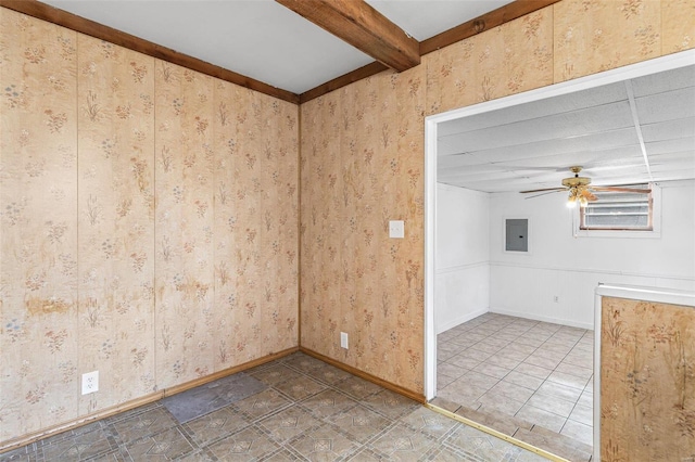 empty room featuring beamed ceiling, ceiling fan, and electric panel