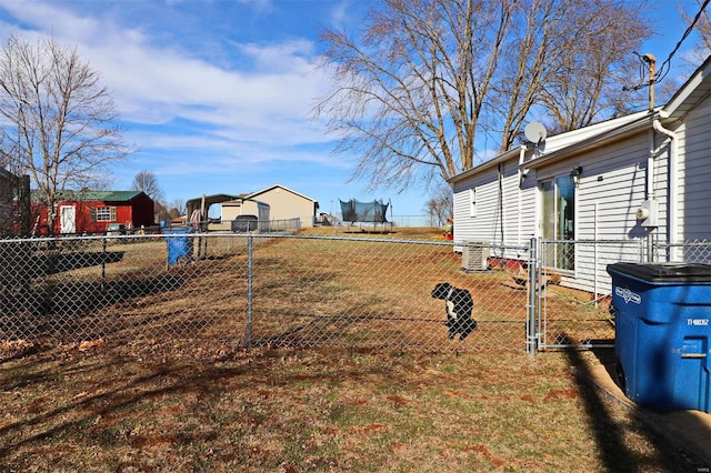 view of yard featuring cooling unit and a trampoline