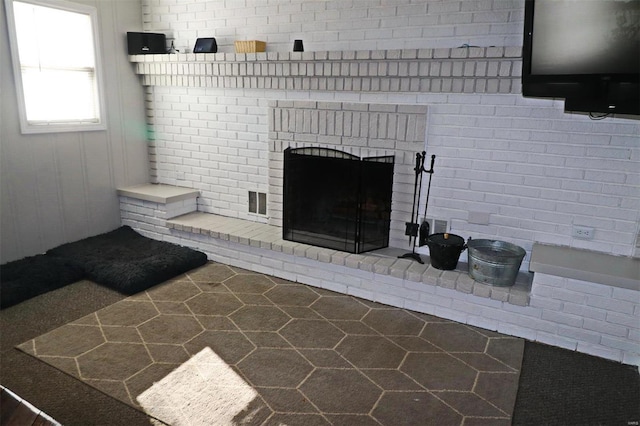 living room featuring a brick fireplace