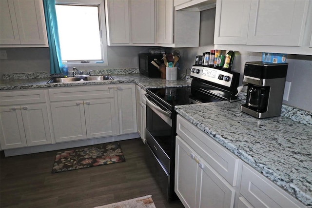 kitchen with sink, white cabinets, and electric stove