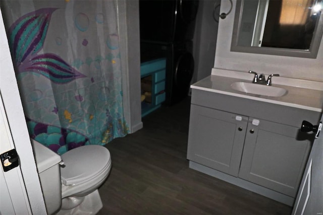 bathroom with wood-type flooring, toilet, and vanity