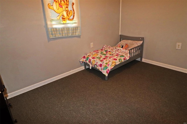 bedroom featuring dark carpet